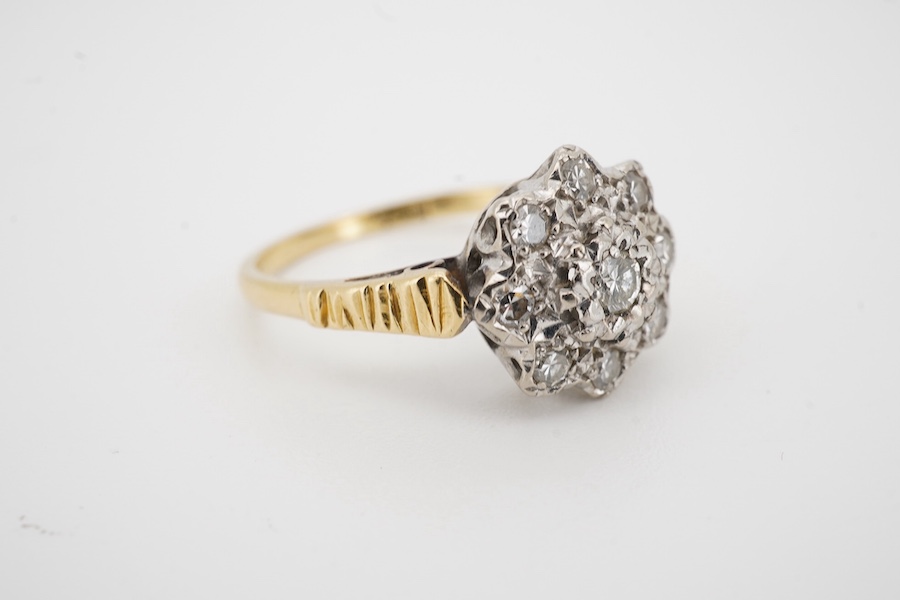 An 18ct and illusion set diamond cluster ring, size M/N, gross weight 3.6 grams. Condition - fair